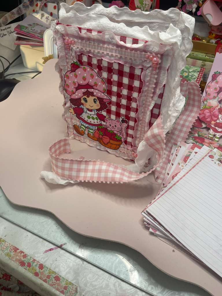 Cover with closure strap and embellishments